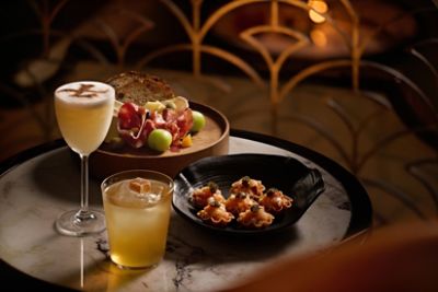 tlhkg-palm-court_bar_cocktails with mini hamachi tart-and-cheese and cold cut platter_3-2_2025_rgb